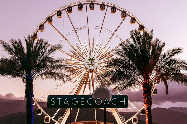 The image shows a Ferris wheel at sunset, framed by palm trees, with a crowd below and a sign reading 